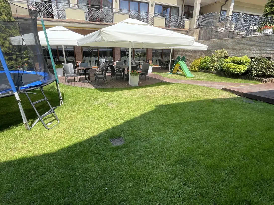 Ogródek z trampoliną i parasolami